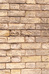 Weathered yellow brick wall