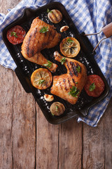 Chicken legs grilled on a grill pan close-up vertical top view