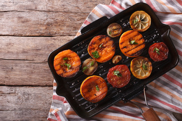 pumpkin and vegetables on grill pan. Top view horizontal 
