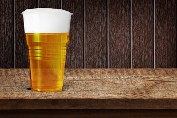 Beer. Golden beer, ale or lager in a plastic disposable cup or