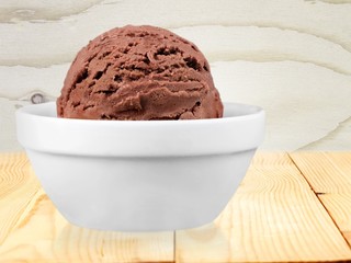 Ice. Scoop of chocolate ice cream in bowl on white background
