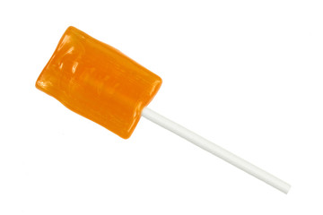Orange lollipop isolated on white background.