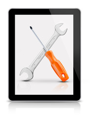 Screwdriver and wrench on tablet