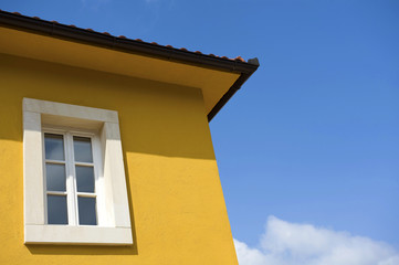 White window on yellow house