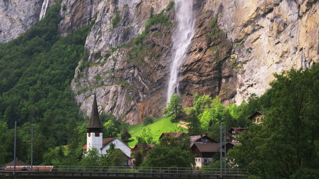 village at the base of a mountain waterfall