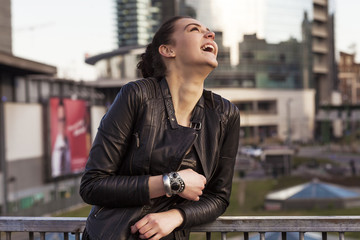 Beautiful girl laughing in the city