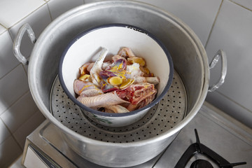 Raw chicken in steamer