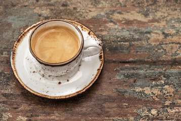Cup of black coffee on wooden background