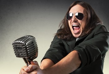 Singing. Retro image of man singing into microphone