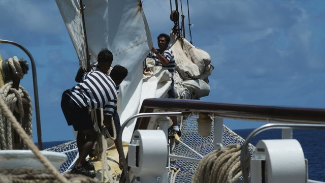 sailors working on a sailboat