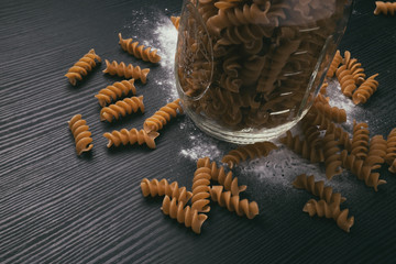 Whole grain pasta in a mason jar with flour
