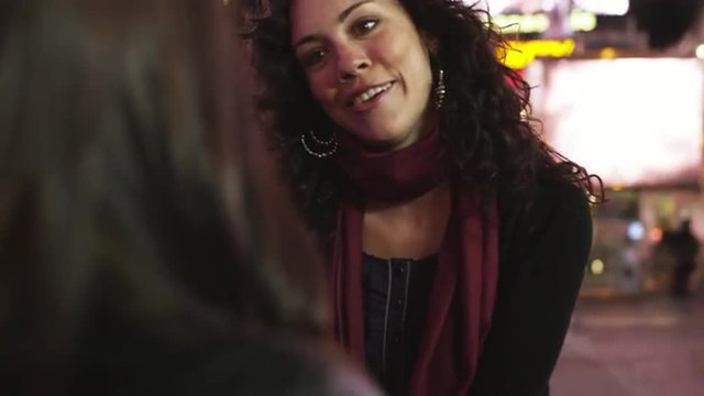 SLO MO CU DS SELECTIVE FOCUS Woman giving autographs in Times Square at night, New York City, USA