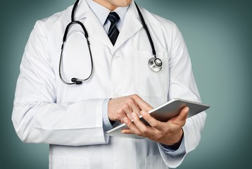 Doctor. Doctor using a digital tablet
