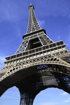 Eiffel Tower paris france low view looking up upwards blue sky background photo vertical