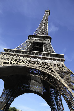 Eiffel Tower paris france low view looking up upwards blue sky background photo vertical