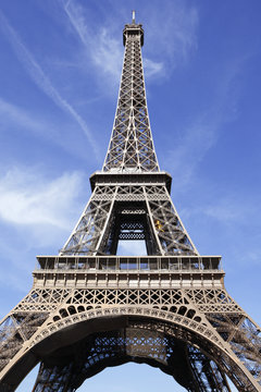 Eiffel Tower paris france front view looking up upwards blue sky background photo vertical