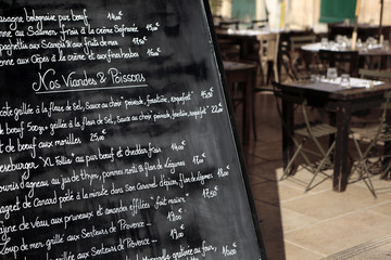Paris France French restaurant with menu board and customer seating in the background photo
