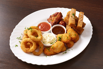 Fast food. Dish with snacks and sauces, close-up