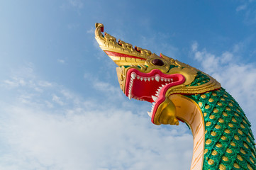serpent king or king of naga statue in thai temple on blue sky b