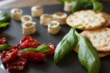 crackers with goat cheese, sun-dried tomatoes and basil