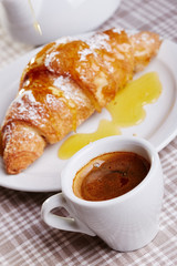 Cup of coffee with croissant