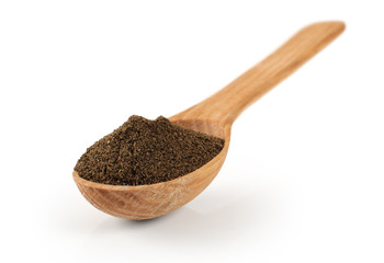 Spoon with pepper on a white background