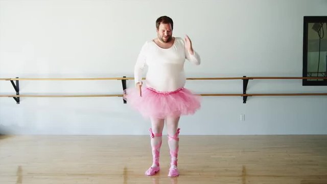 WS Overweight man wearing ballerina costume practicing in ballet studio / Orem,Utah,USA