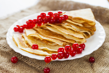 pancakes and berries of currant in a plate