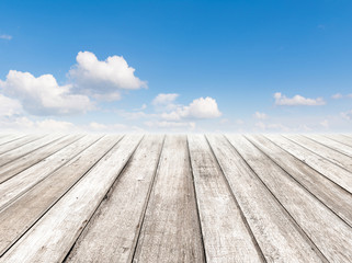 Naklejka na ściany i meble Cloudy blue sky and wood floor, background image