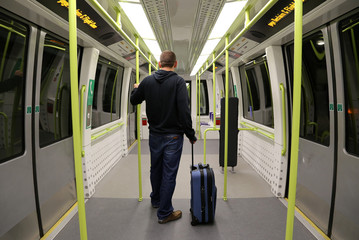 Man with Suitcase on an empty train. © photographyttl
