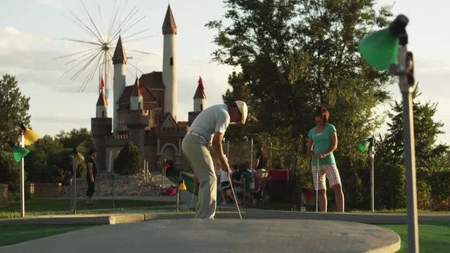 MS Man playing mini golf, suddenly running around waving hands, Orem, Utah, USA