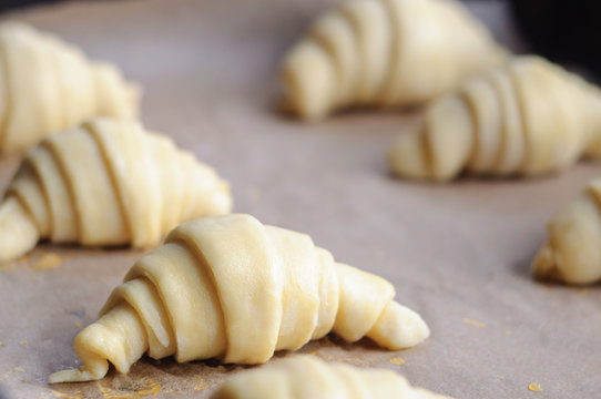 Not baked croissants on oven-tray