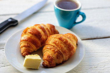 Breakfast with fresh baked croissants, butter and coffee