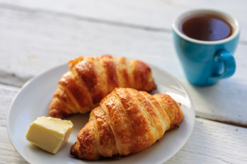 Breakfast with fresh baked croissants, butter and coffee