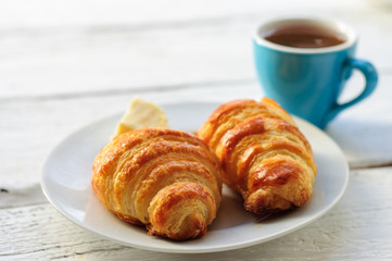 Breakfast with fresh baked croissants, butter and coffee