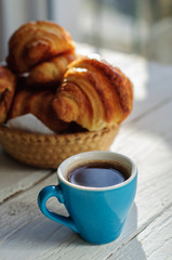 Breakfast with fresh baked croissants, butter and coffee
