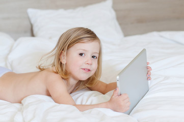 little girl with a tablet in hands