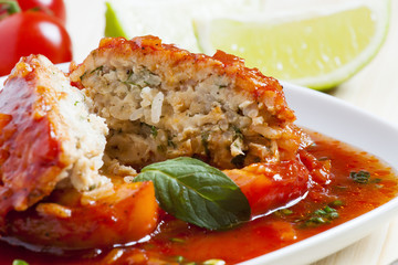 Bell peppers stuffed with meat, rice  and sauce on plate