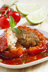 Bell peppers stuffed with meat, rice  and sauce on plate