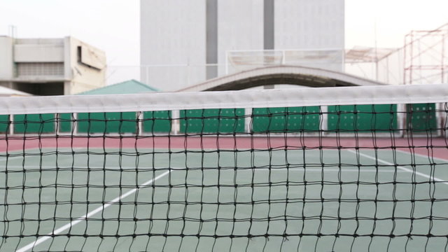 Tennis court with net tracking right and up and focus at court