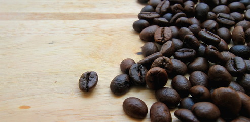 Roasted brown coffee beans,on wood background
