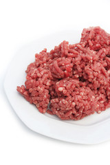 carne macinata cruda su piatto su sfondo bianco