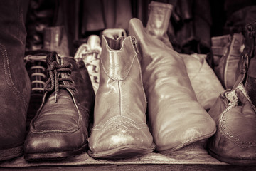 some old shoes on a flea market stall