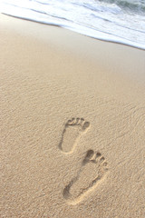 Fototapeta na wymiar footprints on the sand beach