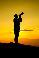 Businessman shouting for announce through a red loudspeaker