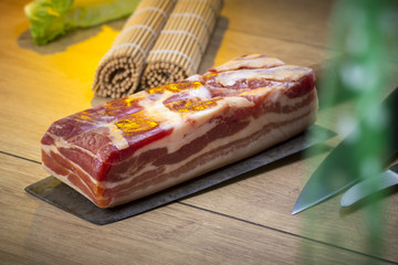 still life with bacon and knifes on a kitchen countertop