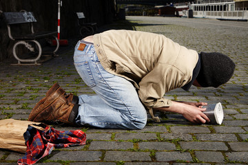 Young ugly beggar on street