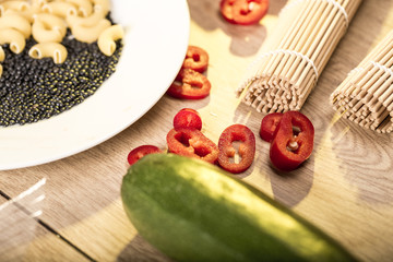 raw pasta and black beluga lentils on a countertop with zucchini