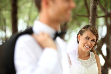 Fototapeta premium beautiful bride smiling and looking at her groom
