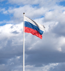 Fototapeta na wymiar Russian flag on the flagpole waving on cloudy sky
